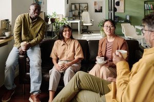 Group of friends drinking coffee at a sober living location of Sober Apartments of America.